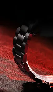 Detail of matte black stainless steel watch strap with brushed metal texture