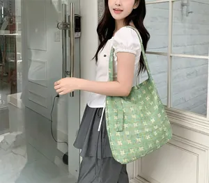 Detail of green floral canvas tote bag showing lightweight fabric and floral print