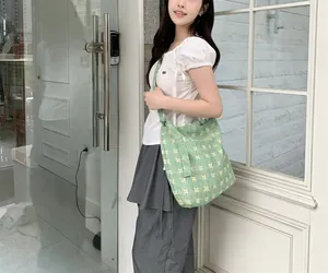 Floral canvas tote bag with small yellow and white flowers on a soft green background