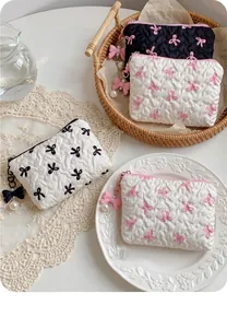 Quilted bow cosmetic bags with pearl pendants in assorted color contrast styles