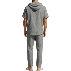 Rear view of men's casual grey linen suit featuring short-sleeved hoodie and loose pants