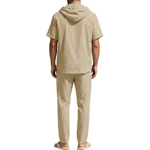 Rear view of men's beige cotton linen hooded short sleeve top and loose matching trousers