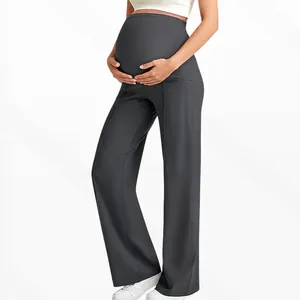 Detail view of high-waist maternity wide leg trousers with side pockets in dark grey