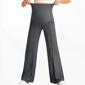 Detail showing the high elastic belly support and vertical seams of grey maternity pants