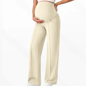 Detail of high waist maternity wide leg pants in beige with elastic belly support band