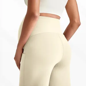 Detail of high-waisted maternity leggings with elastic belly support and side pocket