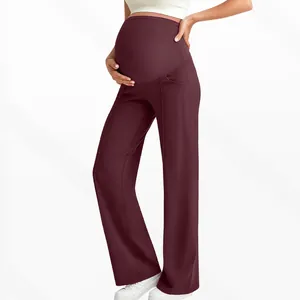 Detail view of burgundy maternity wide-leg pants with high waist belly support