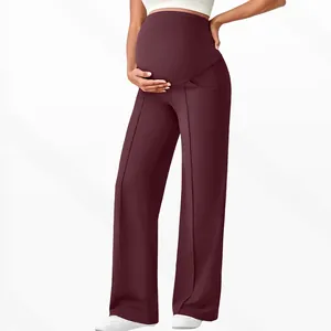 Macro detail of high waist belly support and seam on burgundy wide leg maternity pants