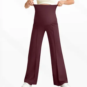 Close-up of high waist belly support and stretch on dark wine red maternity trousers