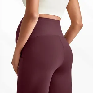 Detail of high-waist maternity yoga pants in burgundy with side pocket and stretchy fabric