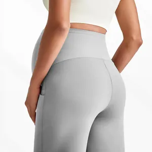 Close-up of high-waisted maternity yoga pants with a side pocket in light grey