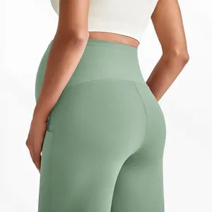 Close-up of sage green maternity yoga pants featuring high waist and side pocket