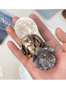 Three-piece acetate hair claw set featuring marble texture and shell spiral design