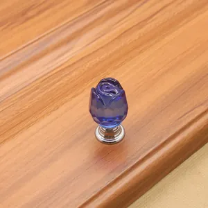 Macro shot of a blue crystal rose drawer knob with a polished silver metal base