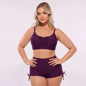 Detail of high waisted plum two-piece bikini with bow front and side ties