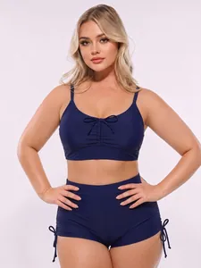 Dark blue high waisted two-piece swimsuit with drawstring shorts and front bow detail