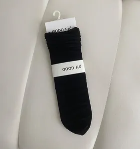 Detailed close-up of breathable black mesh socks with a stylish ruffled cuff design