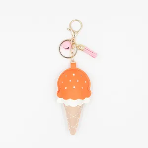 Détail du porte-clés crème glacée en cuir PU avec pompon rose, cloche et fermoir doré
