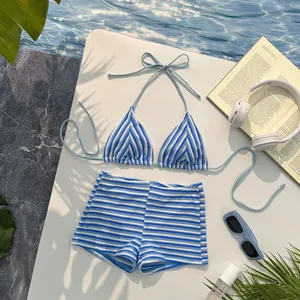 Detailed view of blue and white striped bikini set with halter top and high-waisted shorts
