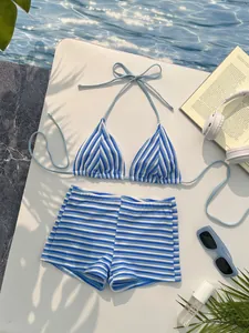 Detail of blue and white striped bikini with high-waisted shorts on water surface