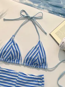 Close-up of blue and white striped terry cloth bikini top with light blue strings