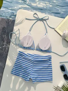 Detail view of blue striped bikini top with removable pads and interior care labels