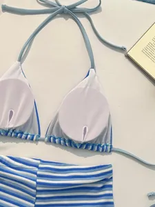 Detail of blue and white striped bikini top with halter neck and removable pads