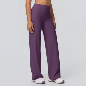 Macro detail of high-waist yoga flared pants in deep plum with brushed texture fabric