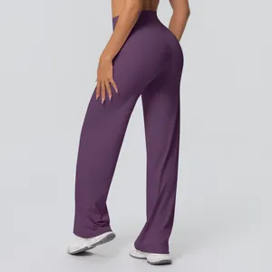 Rear view of dark purple high-waisted yoga flare pants showing slimming lift effect