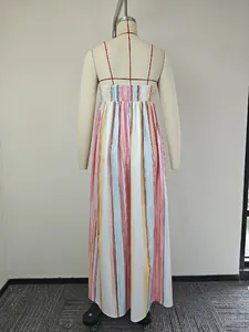 Detail of the colorful vertical striped maxi dress with a smocked back and thin red straps