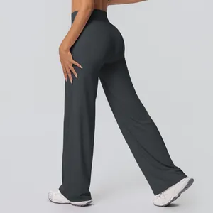 Detail view of high-waist flared yoga pants in dark grey showing breathable fabric