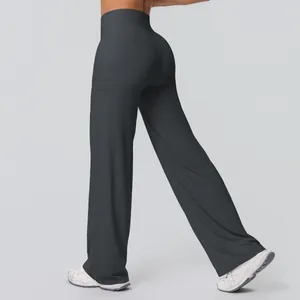 Detail view of high-waisted charcoal grey flared yoga pants with elastic fabric