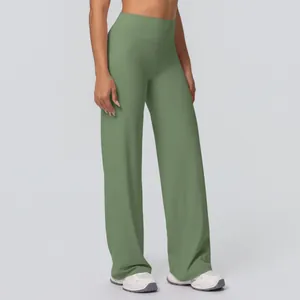 Detail of high-waist yoga pants in sage green with elastic straight-leg fit and soft texture