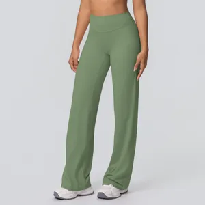 Detailed close-up of high-waist flared yoga pants in dusty sage green breathable fabric