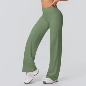 Detail of high waisted wide leg yoga pants in sage green with flared hem design