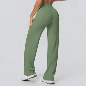 Back view of olive green high waisted wide leg yoga pants on model in studio