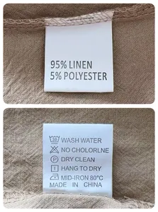 Détail macro du tissu en lin pour homme et étiquette d'entretien montrant 95% de lin