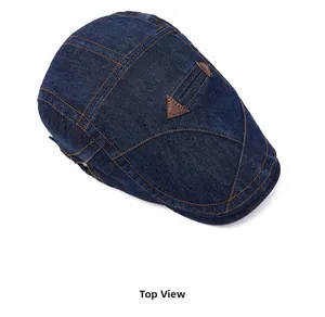 Vue de dessus du béret en jean bleu foncé avec coutures contrastées et patch en cuir