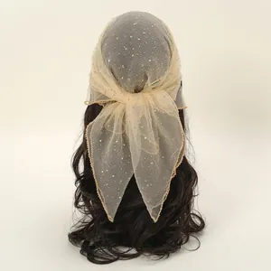 Close-up of sparkling rhinestones on mesh headscarf with wave gold edge detail