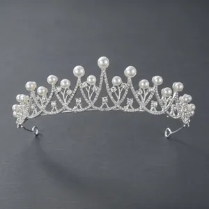 Elegant silver bridal tiara crown featuring white pearls and shimmering rhinestones