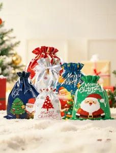 Detail of Christmas drawstring gift bags with festive patterns and ribbon closure