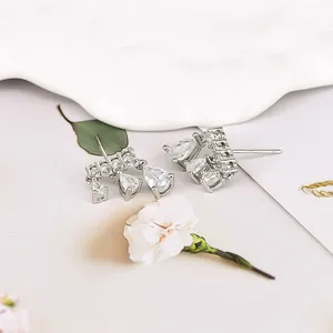 Detailed view of S925 silver needle drop earrings with sparkling zircon stones
