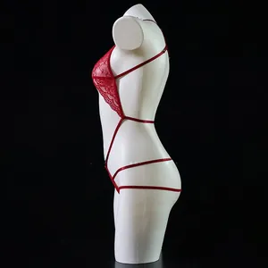 Detail of red lace teddy lingerie with strappy cross-back design on mannequin