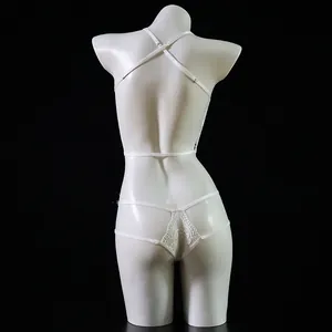 Detail of white lace lingerie showing crisscross back straps and hollow lace texture