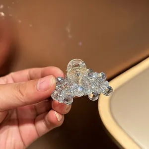Macro detail of a crystal beaded hair claw clip with golden metal spring closure