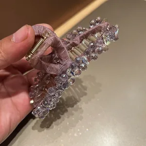 Detailed view of large purple crystal hair claw clip with intricate beaded texture