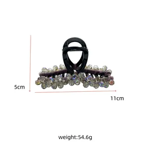 Macro view of purple crystal hair claw clip showing 11cm length and faceted bead detail