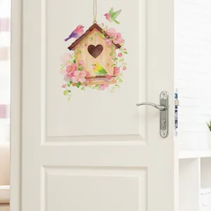 Floral birdhouse wall sticker with heart detail and colorful birds on a white door