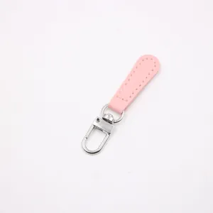 Detailed view of a pink leather zipper pull with precise stitching and a silver metal clasp