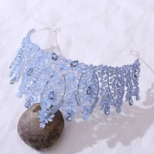 Macro detail of Baroque bridal tiara featuring light blue leaf stones and dark crystals